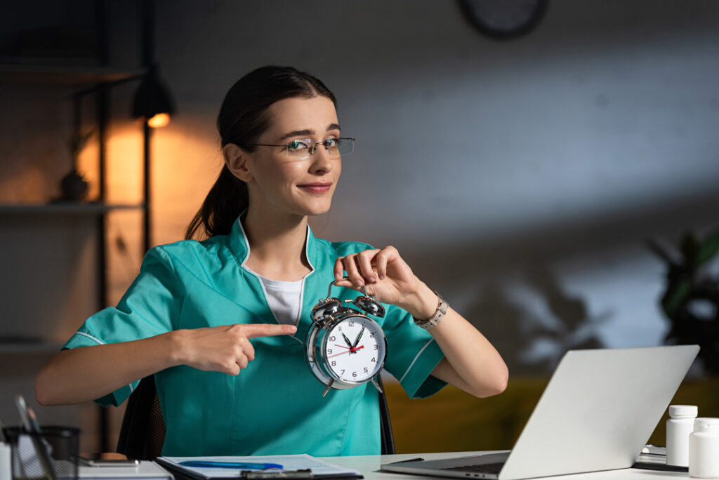 attractive nurse in uniform and glasses sitting at 2023 11 27 05 00 08 utc