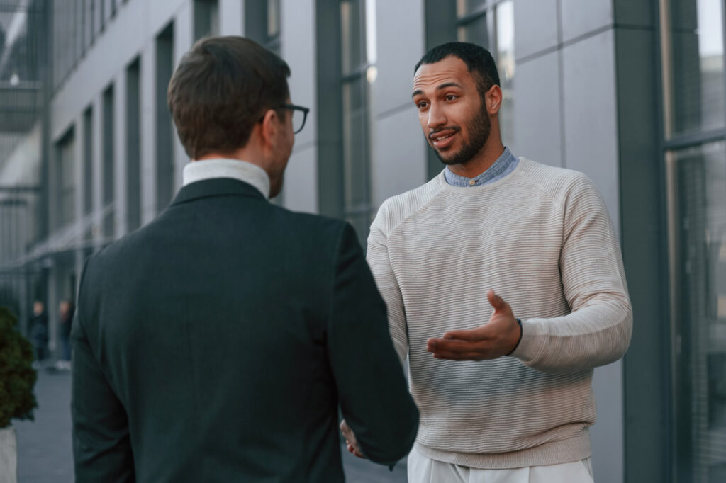 businessman in formal clothes is with black man ou 2023 11 27 05 03 29 utc