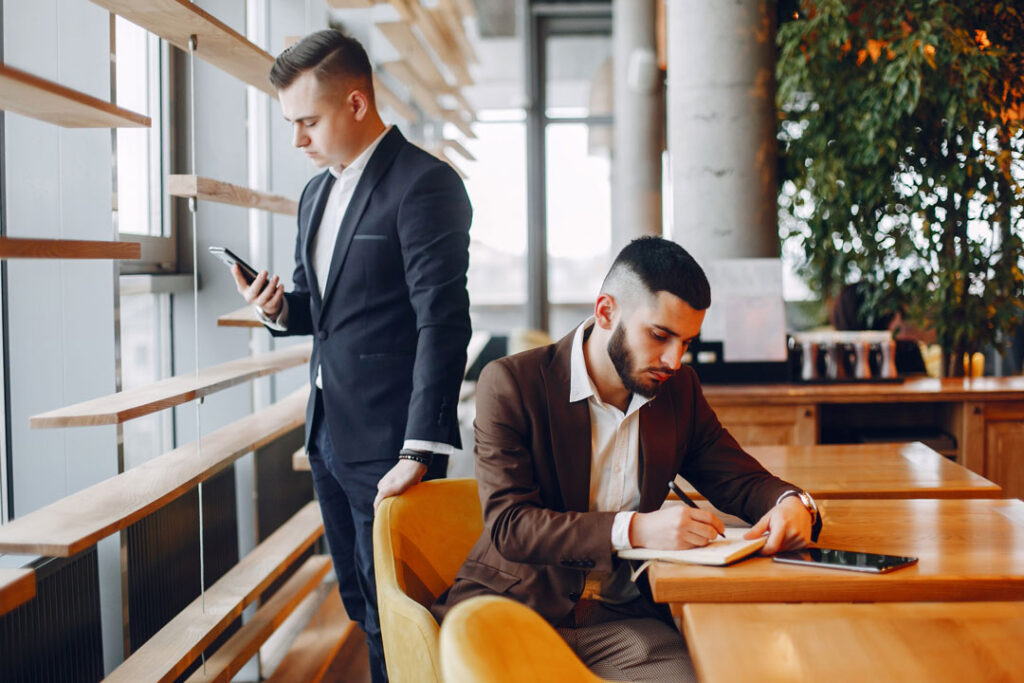 two businessmen working in a cafe 2023 11 27 05 27 08 utc