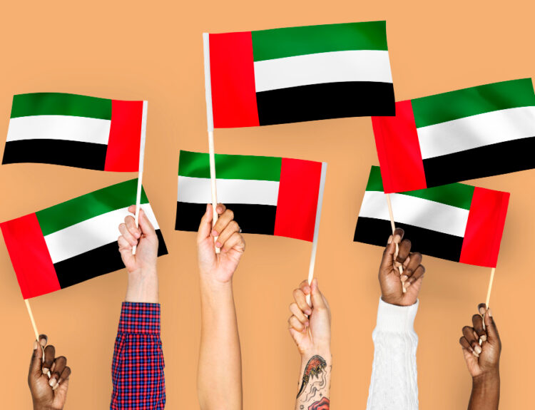 cover banner Free photo hands waving flags of the united arab emirates