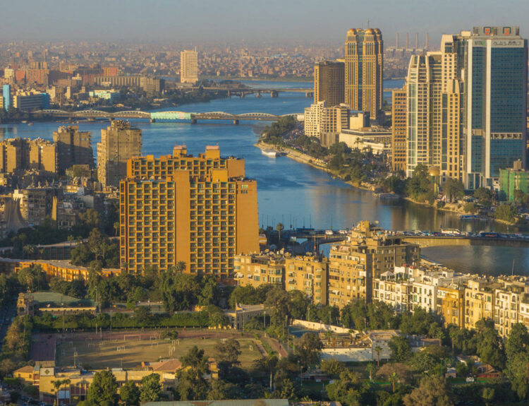 Image used for illustrative purpose. Cairo Skyline along Nile River. The bridge, the Nile river & the Corniche Street in central Cairo.